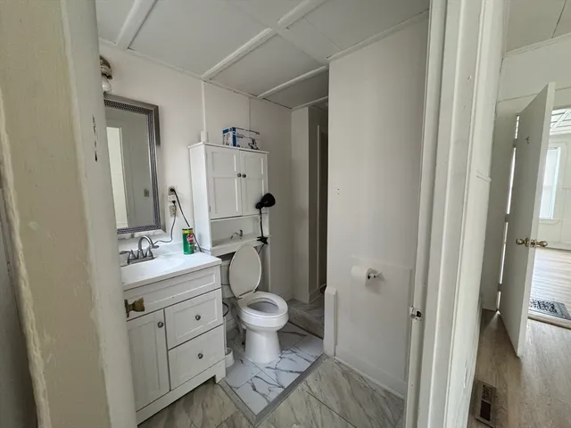 a bathroom with a sink toilet and shower