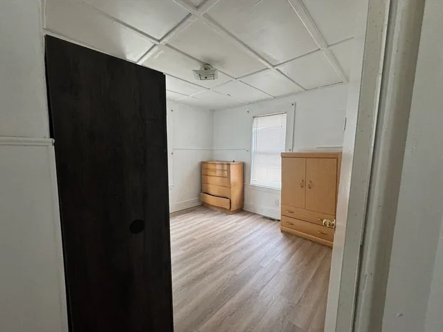 a view of a livingroom with wooden floor and cabinet