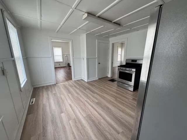 a room with a bed and wooden floor