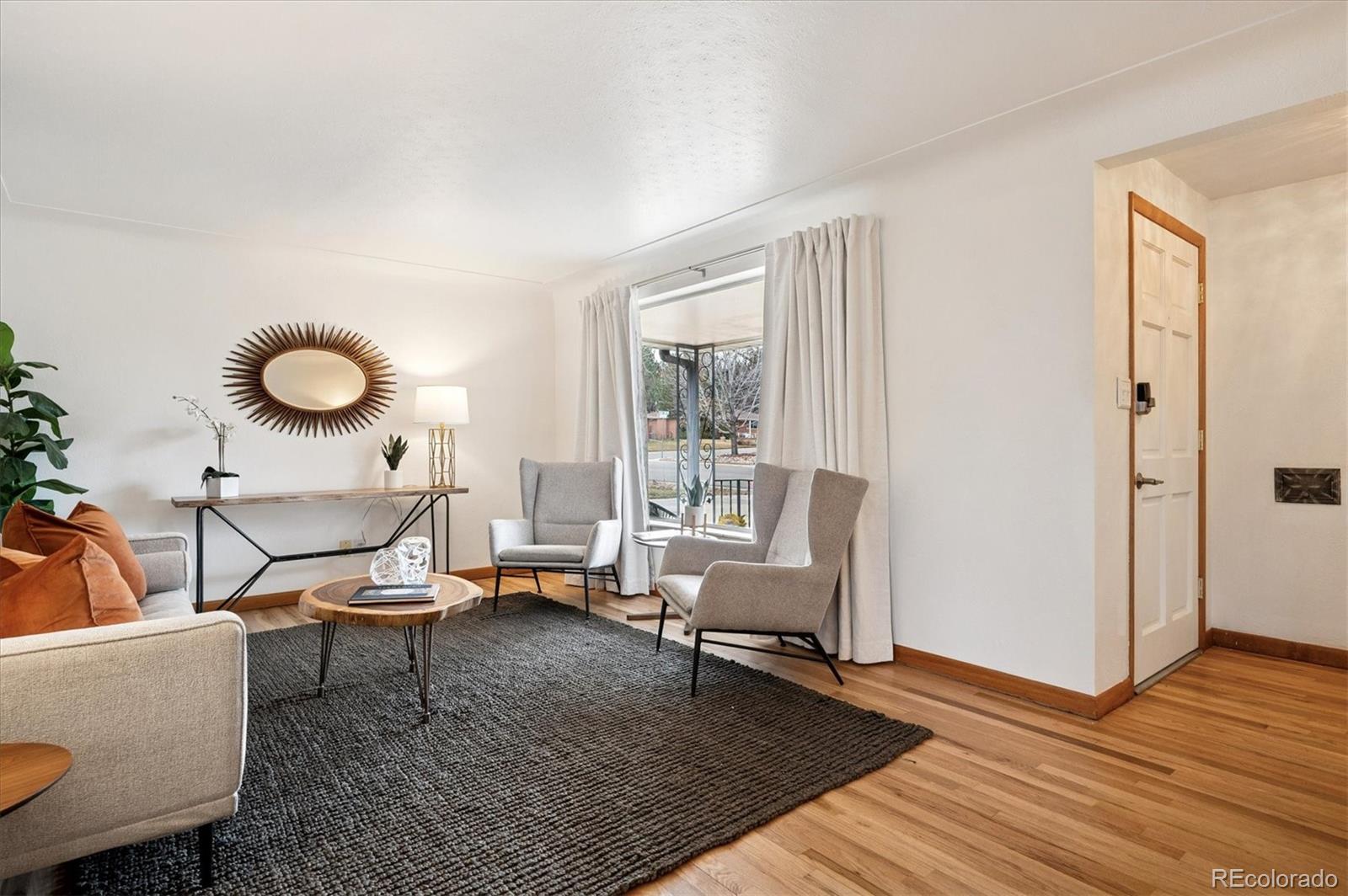 3880 Balsam Street Wheat Ridge, CO 80033 - Photo 14 of 40 a living room with furniture and a wooden floor