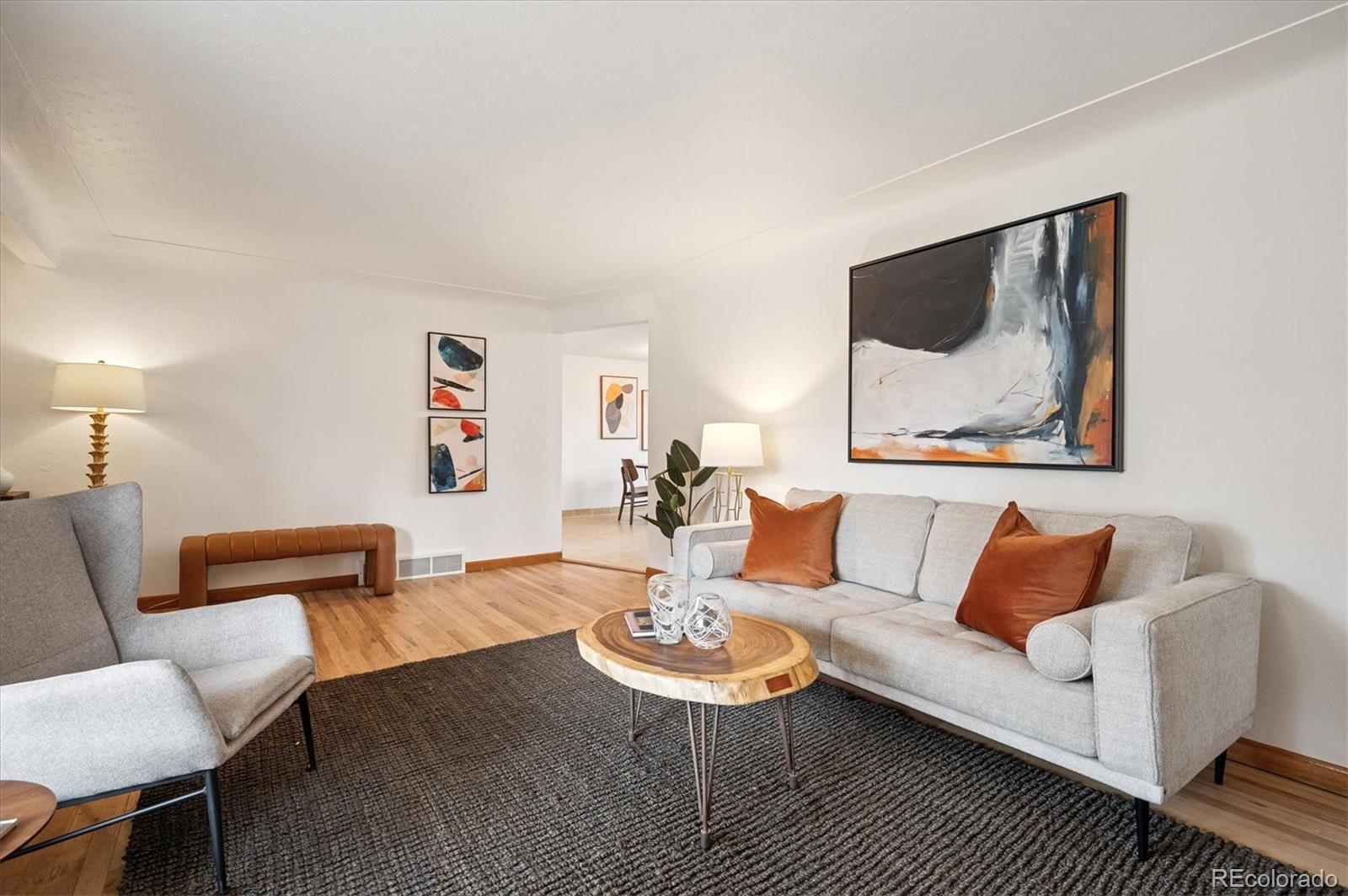 3880 Balsam Street Wheat Ridge, CO 80033 - Photo 16 of 40 a living room with furniture and a wooden floor