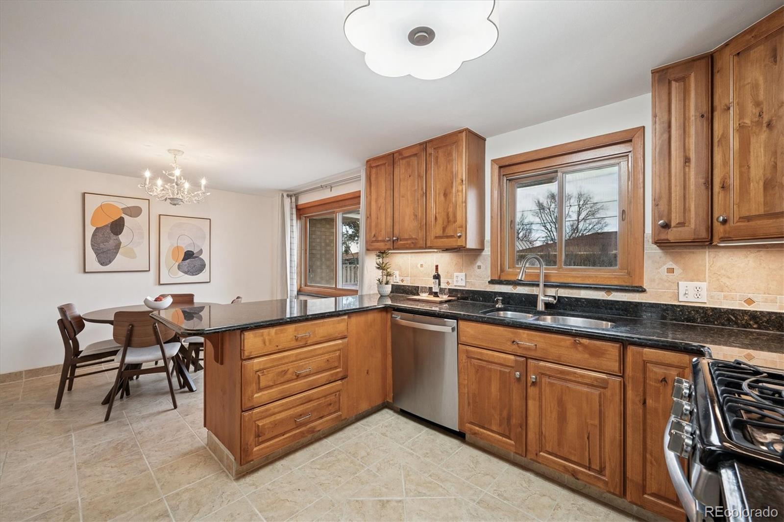 3880 Balsam Street Wheat Ridge, CO 80033 - Photo 20 of 40 a kitchen with granite countertop a sink cabinets and window