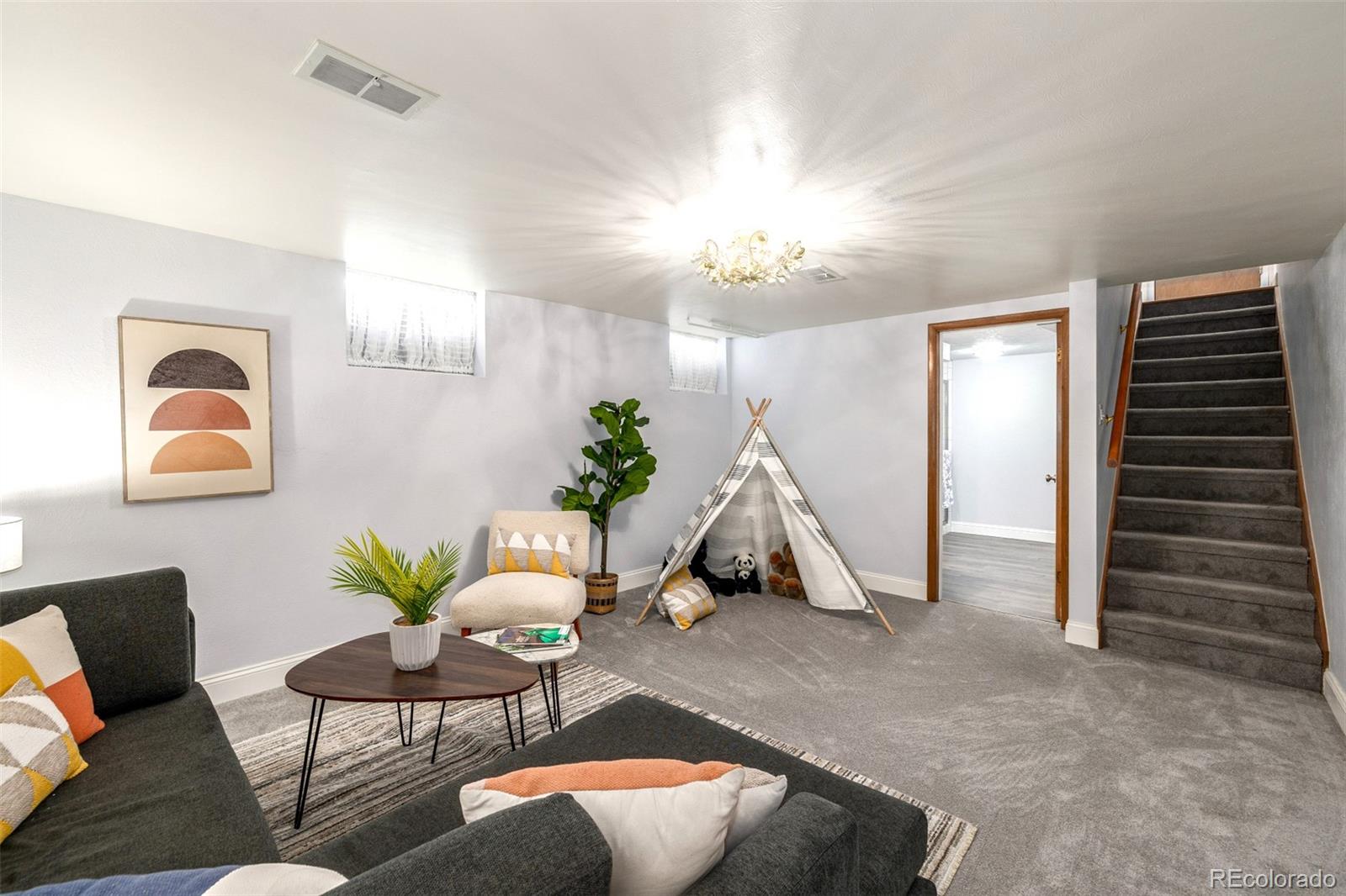 3880 Balsam Street Wheat Ridge, CO 80033 - Photo 27 of 40 a living room with furniture flowers and a window