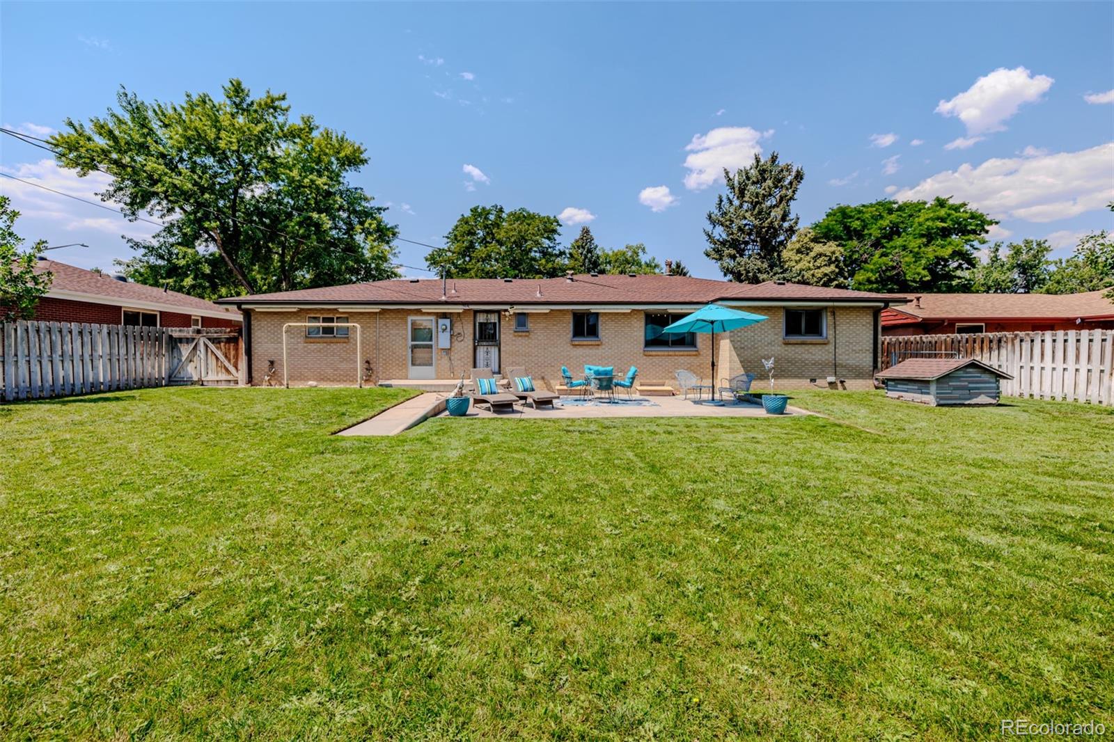 3880 Balsam Street Wheat Ridge, CO 80033 - Photo 36 of 40 a view of a house with backyard sitting area and garden