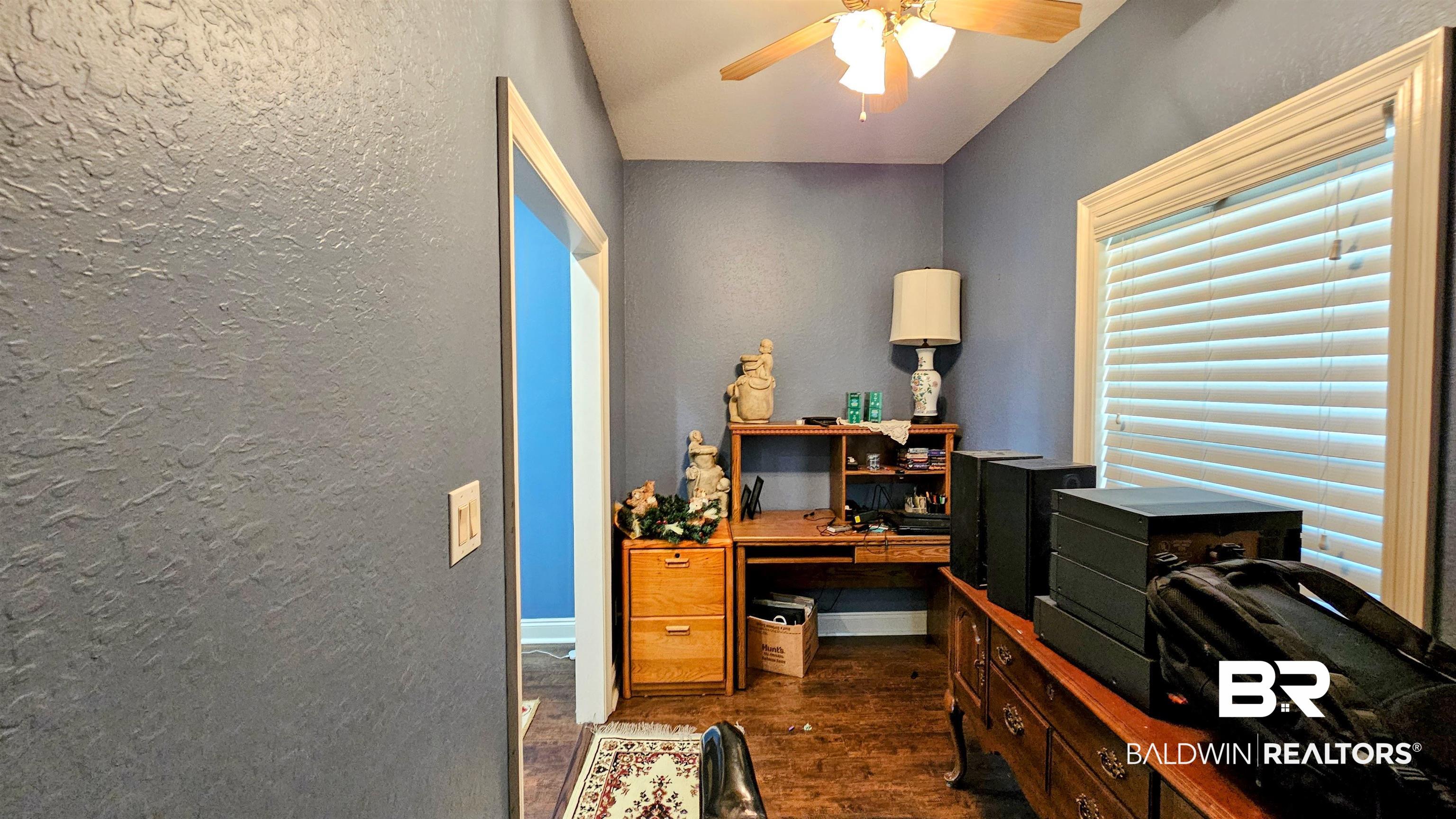 9275 Crawford Road Elberta, AL 36530 - Photo 20 of 28 Office featuring dark wood-style floors, ceiling fan, and a textured wall