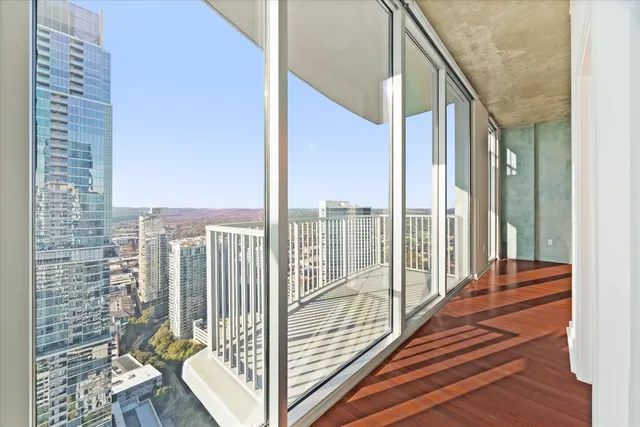 a view of balcony with floor to ceiling windows with wooden floor