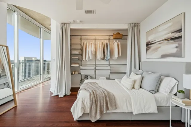 a living room with furniture potted plant and a large window