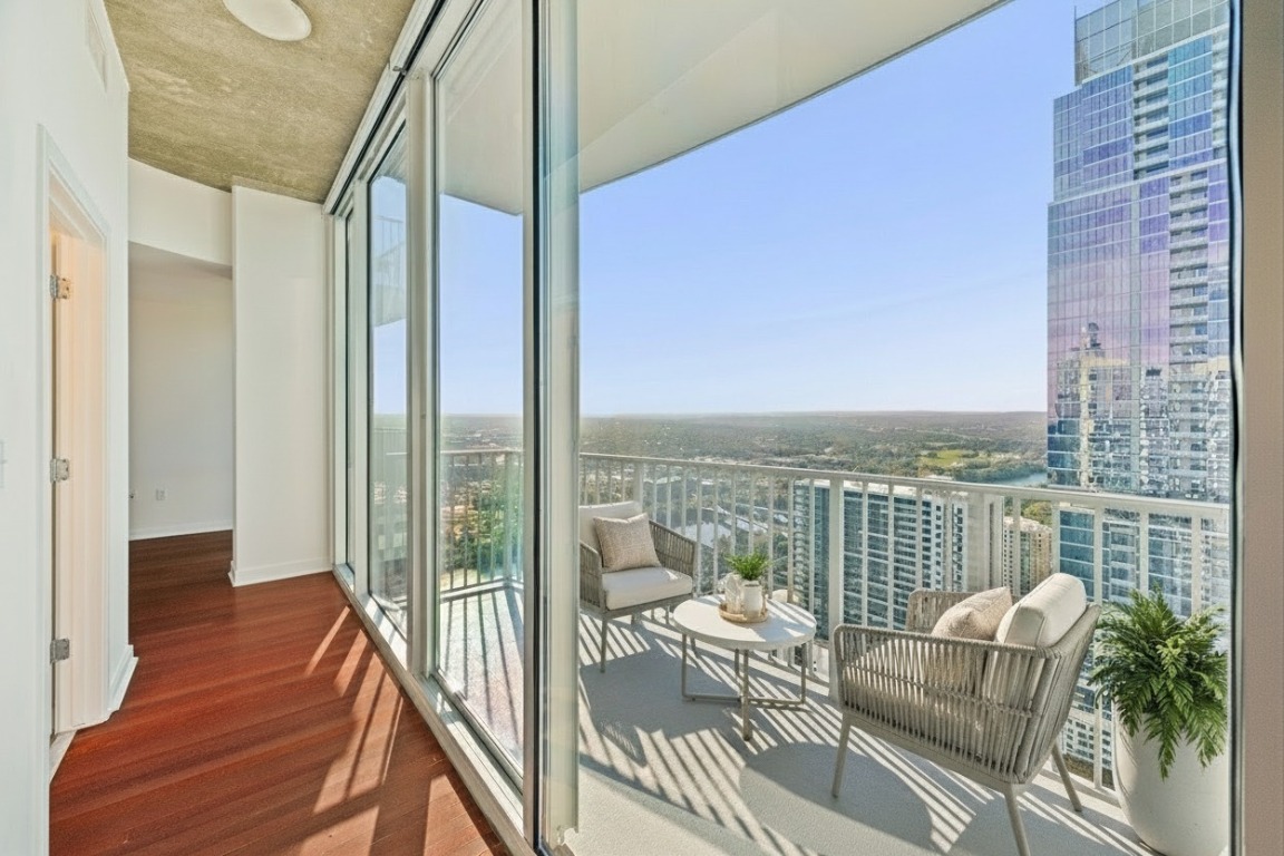 360 Nueces Street, Unit 4008 Austin, TX 78701 - Photo 2 of 40 a balcony with furniture and a floor to ceiling window