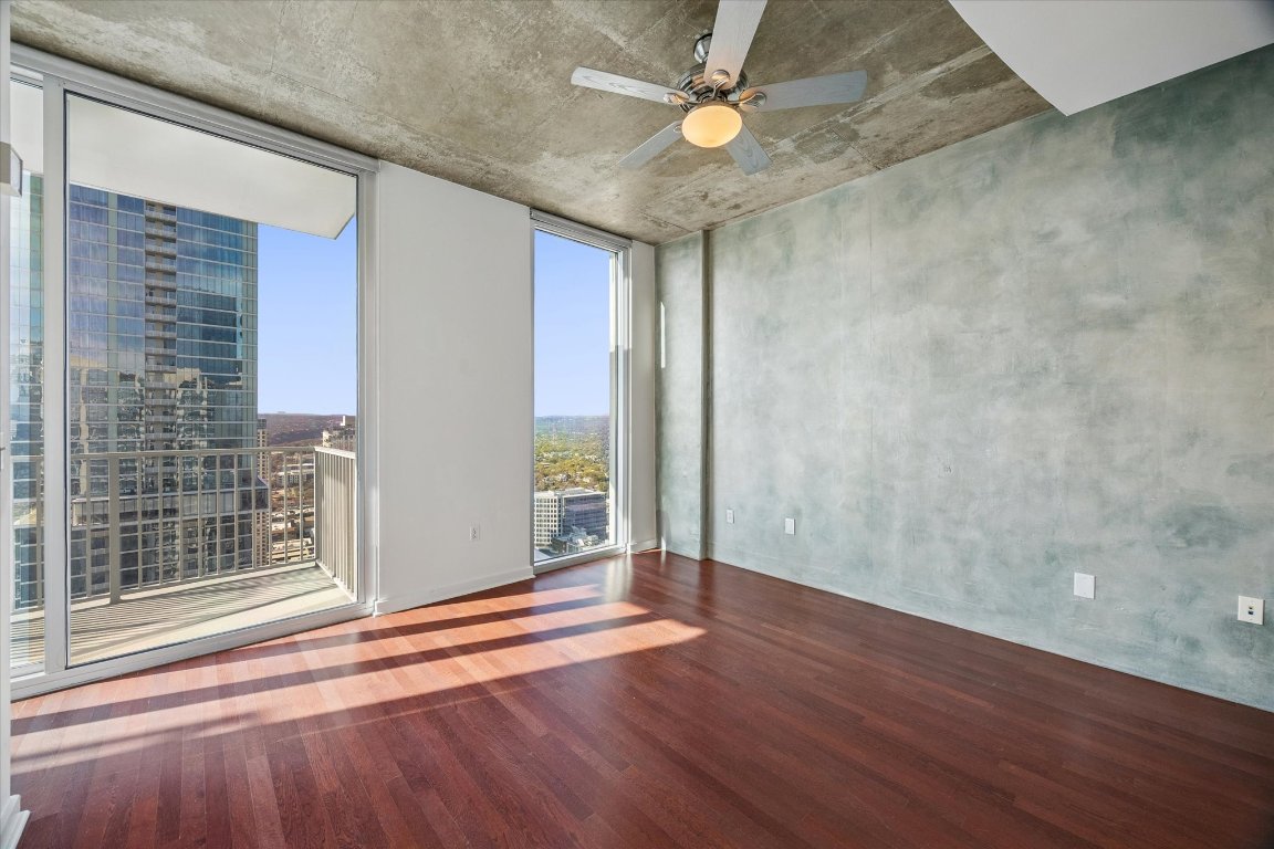 360 Nueces Street, Unit 4008 Austin, TX 78701 - Photo 8 of 40 an empty room with wooden floor and windows