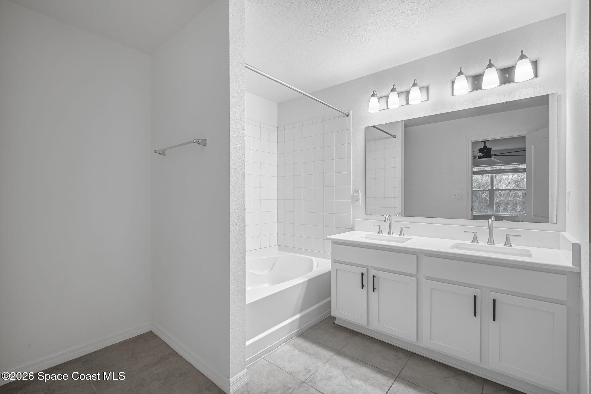 1219 Moscato Drive Titusville, FL 32780 - Photo 12 of 21 a bathroom with a tub sink and mirror