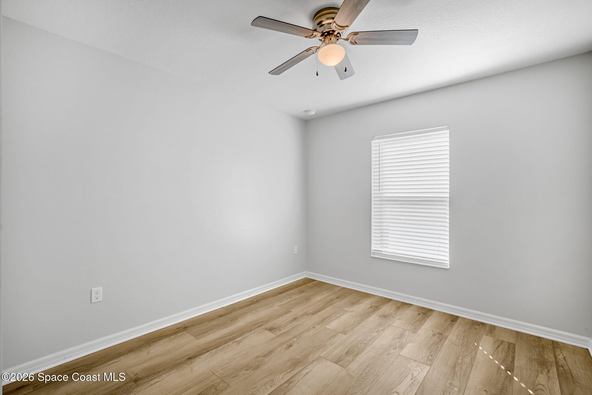 1219 Moscato Drive Titusville, FL 32780 - Photo 13 of 21 an empty room with a window and a fan