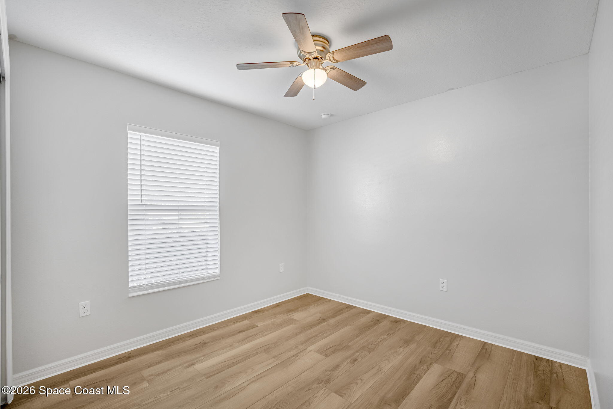 1219 Moscato Drive Titusville, FL 32780 - Photo 14 of 21 an empty room with a window and a fan