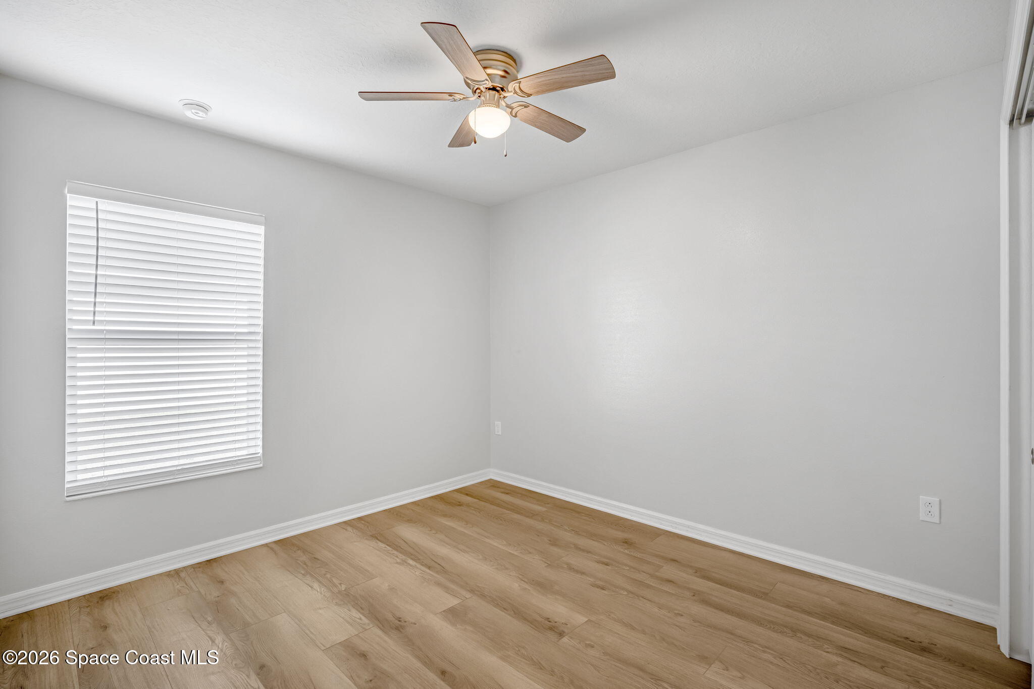 1219 Moscato Drive Titusville, FL 32780 - Photo 15 of 21 an empty room with a window and a ceiling fan