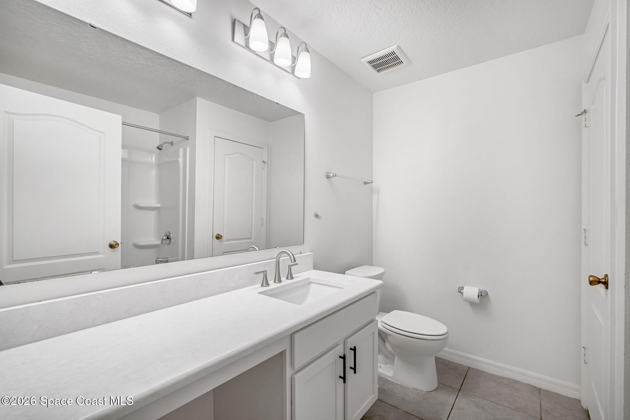 1219 Moscato Drive Titusville, FL 32780 - Photo 16 of 21 a bathroom with a sink a toilet and shower