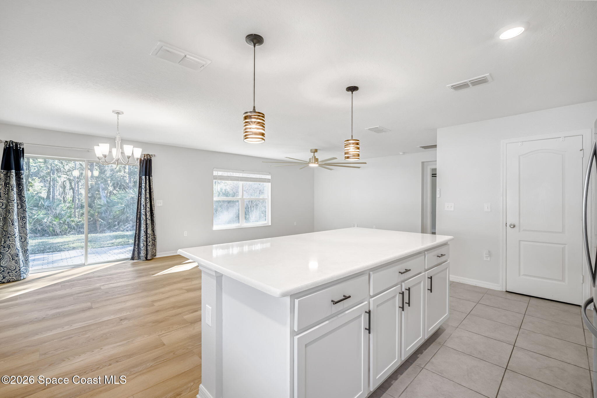 1219 Moscato Drive Titusville, FL 32780 - Photo 6 of 21 a kitchen that has a lot of cabinets and wooden floor