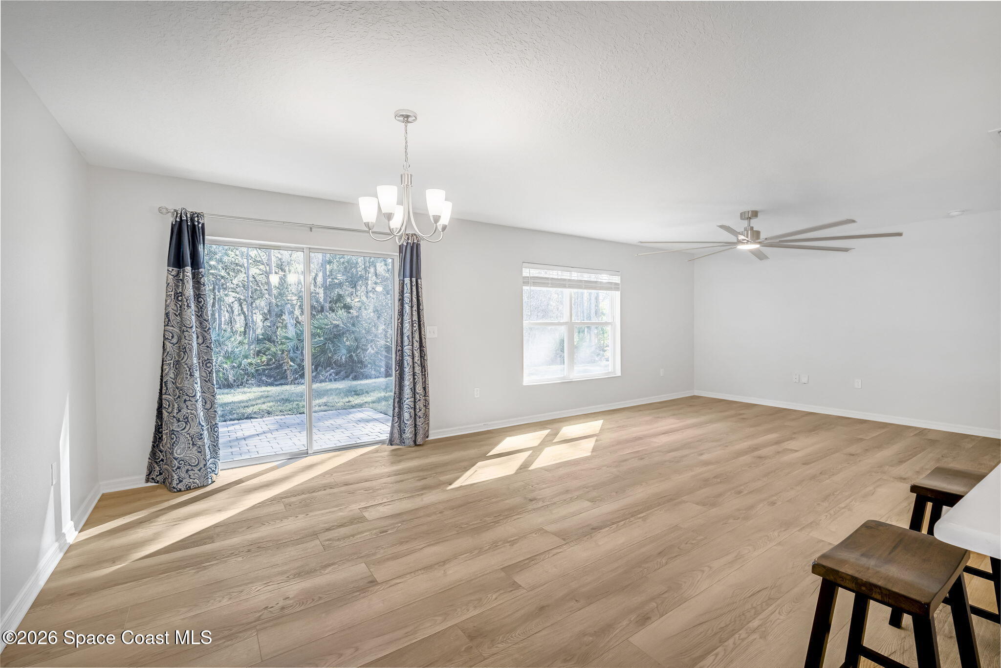1219 Moscato Drive Titusville, FL 32780 - Photo 7 of 21 a view of an empty room with wooden floor and a window