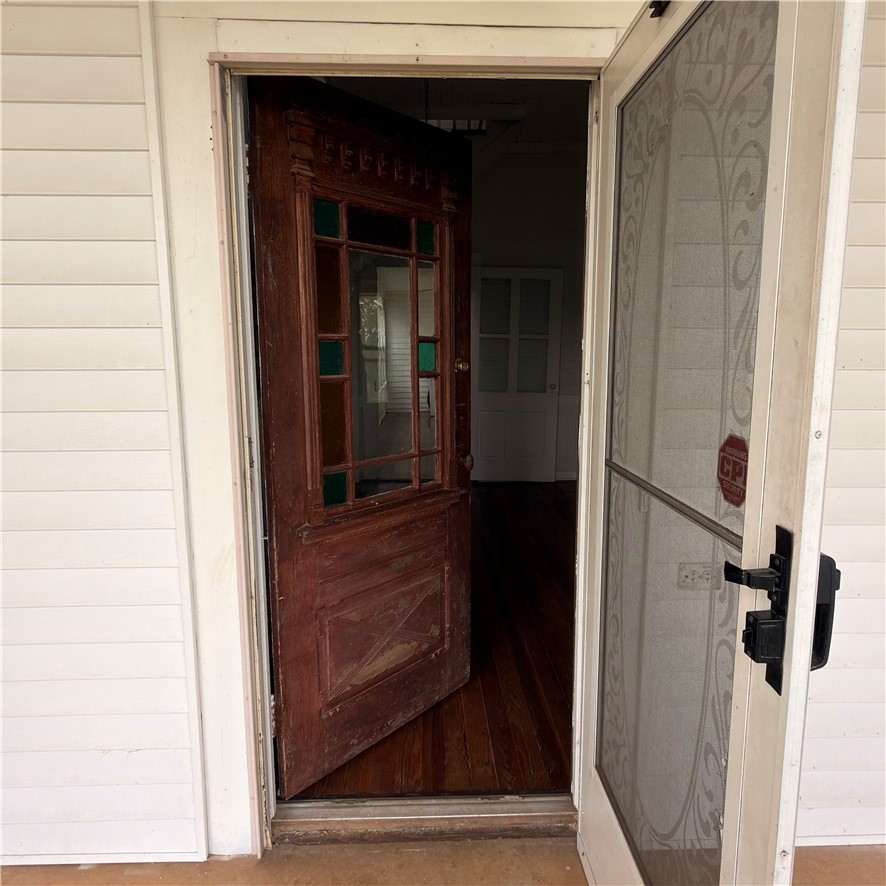 1014 Levis Smith Road Pendleton, SC 29670 - Photo 3 of 21 Enter through this classic wooden door with stained glass, original turnkey bell revealing warm hardwood floors inside.