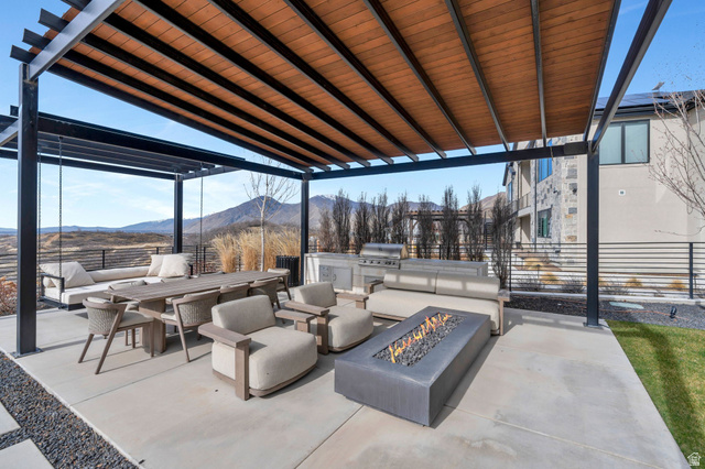 3918 South Mapleton Ests Drive Mapleton, UT 84664 - Photo 77 of 103 View of patio with a fire pit, an outdoor kitchen with living area, a mountain view, and a pergola