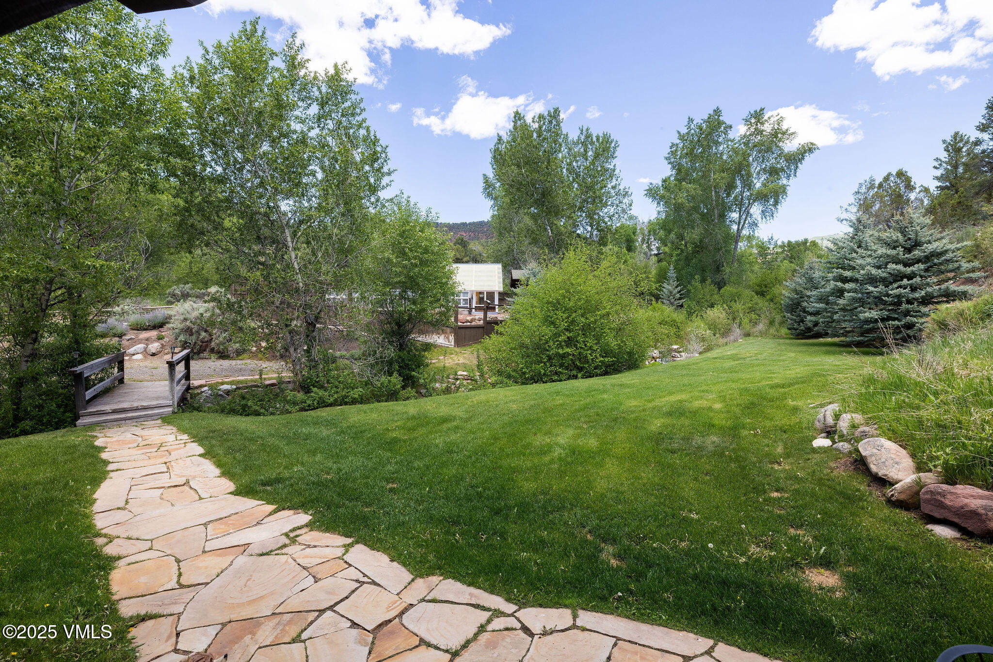 1794 Eby Creek Road Eagle, CO 81631 - Photo 30 of 45 a view of a garden with plants and large trees