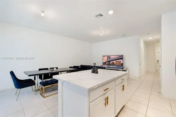 a view of kitchen with furniture and refrigerator