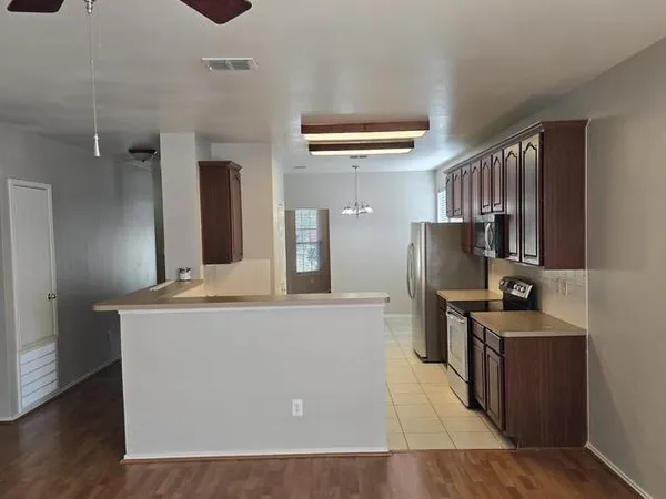 a kitchen with stainless steel appliances granite countertop a stove and a refrigerator