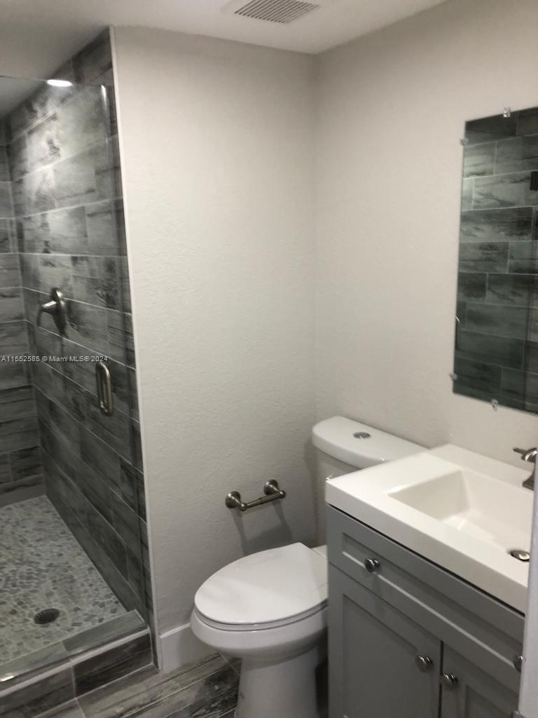 9273 Southwest 8th Street, Unit 310 Boca Raton, FL 33428 - Photo 15 of 21 a bathroom with a sink and toilet