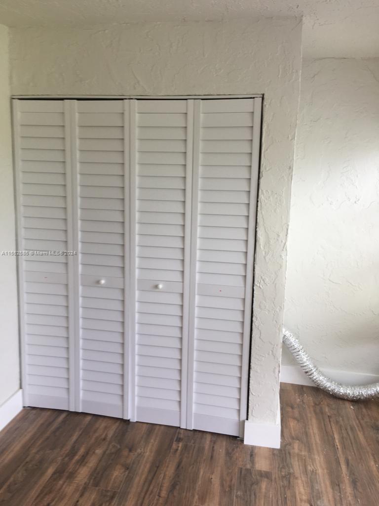 9273 Southwest 8th Street, Unit 310 Boca Raton, FL 33428 - Photo 17 of 21 a view of a room with wooden floor
