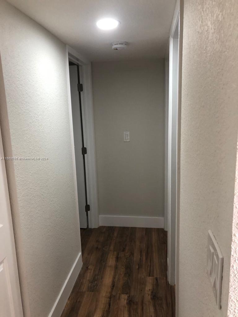 9273 Southwest 8th Street, Unit 310 Boca Raton, FL 33428 - Photo 2 of 21 an empty room with wooden floor