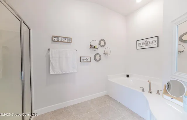 a bathroom with a bathtub and shower
