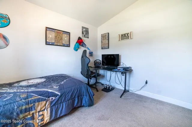 a bedroom with a bed and a desk