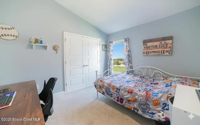 a bedroom with a bed and a table in it