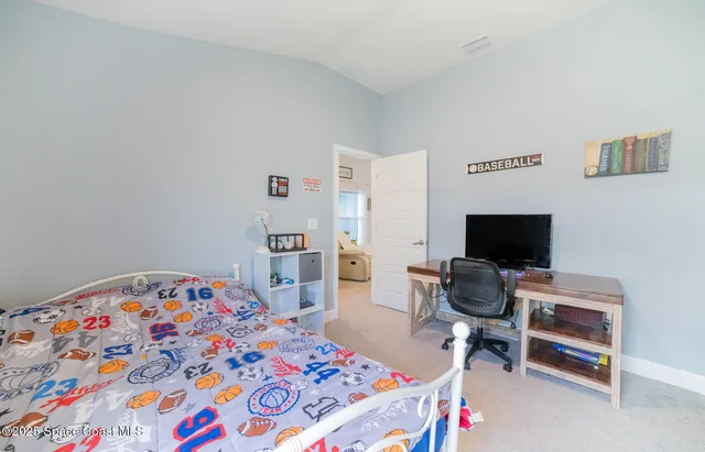 a bedroom with a bed and a desk