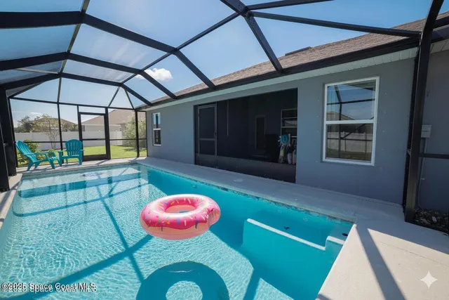 a view of a room with table and chairs