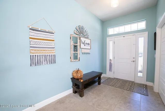 a living room with a baby crib furniture and a window