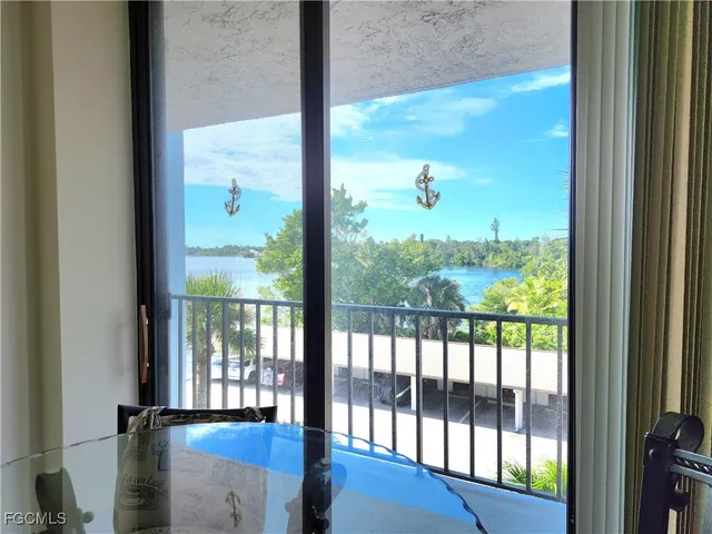 a view of a glass door with a yard from a window