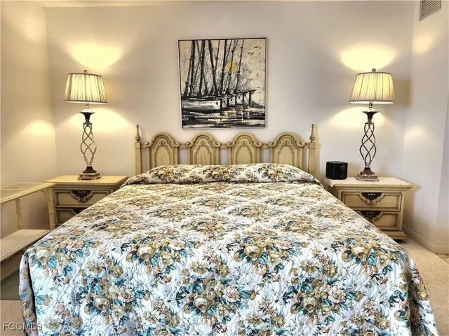 a bedroom with a bed and a lamp