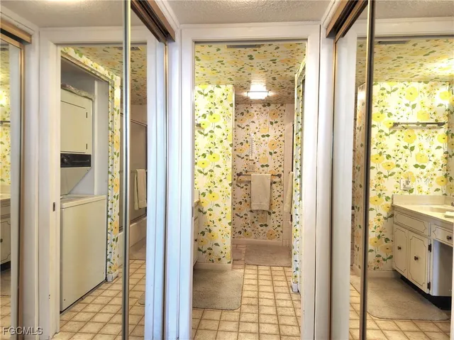 a bathroom with a glass shower door and a wooden floor