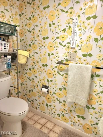 a white toilet sitting next to a shower curtain