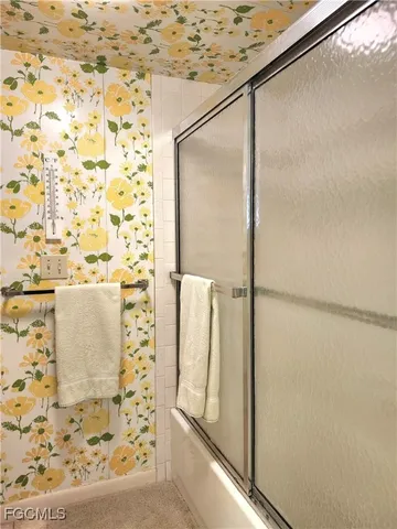 a bathroom with a shower and a mirror