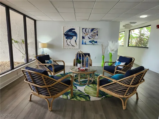 a living room with furniture a rug and a large window