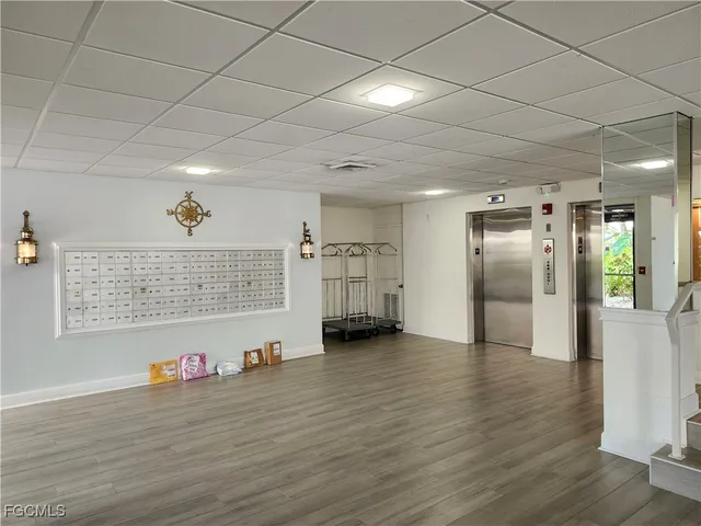 a view of empty room with wooden floor and window