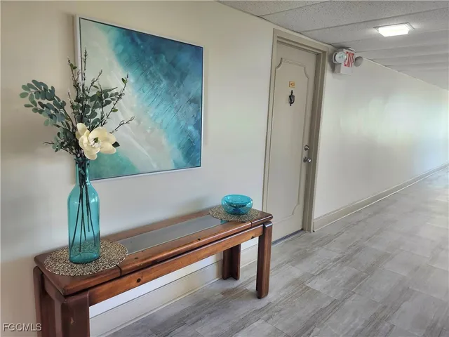 a room with wooden floor and potted plant