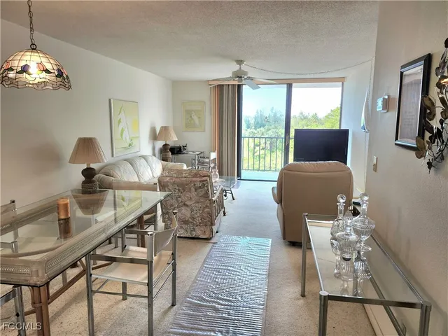 a living room with furniture wooden floor and a chandelier
