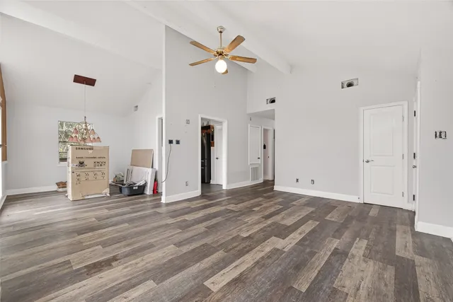 a view of a livingroom with a hardwood floor and a ceiling fan