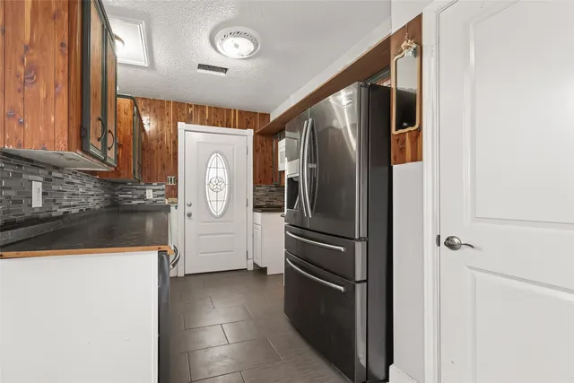 a kitchen with stainless steel appliances granite countertop a refrigerator and a stove