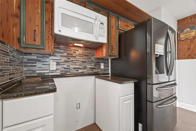 a kitchen with appliances a sink and cabinets