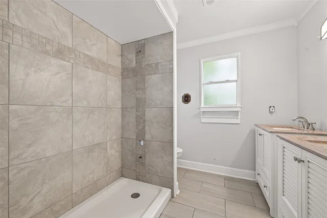 a bathroom with a shower a sink and mirror