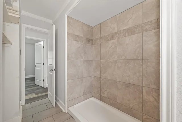 a bathroom with a shower and a sink