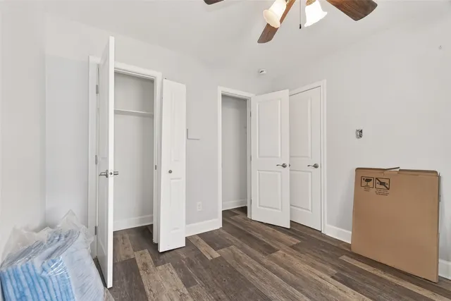 a view of a bedroom with wooden floor