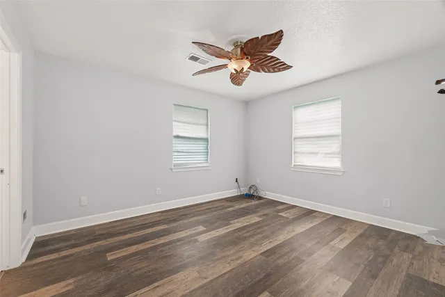 a view of a room with wooden floor and windows